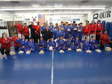 Group photo of Taekwondo students and adults.