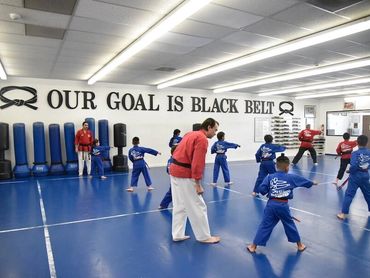 Martial arts class with instructor and students.