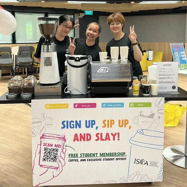 Three people at a coffee booth promoting student membership with a cheerful vibe.