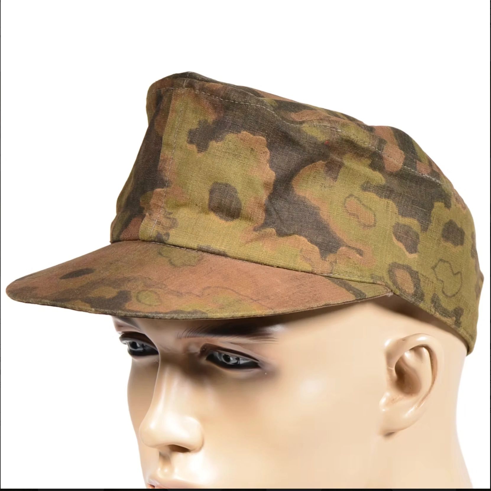 Camouflage military cap on mannequin head.