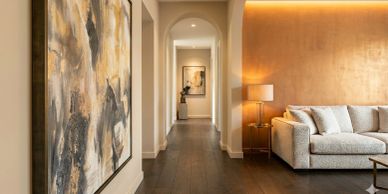 Modern living room and hallway with artwork.