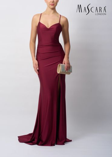 Woman in a burgundy evening gown holding a clutch.