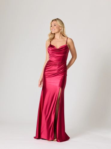 Woman in a red satin evening gown with a thigh slit.