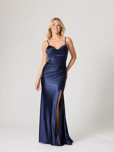 Woman in a navy blue satin gown with a slit.
