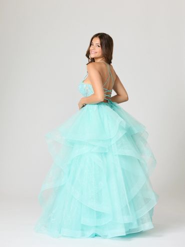 Young woman in a flowing blue gown smiling.
