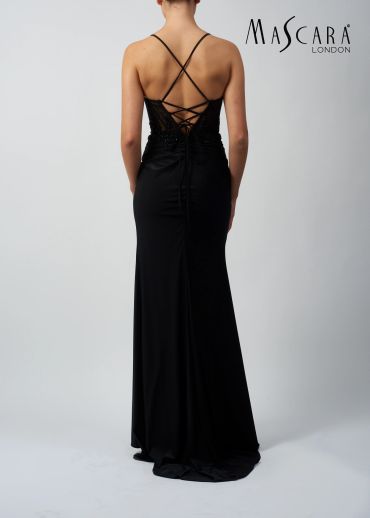 Woman in elegant black evening gown with lace-up back.