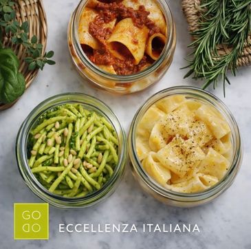Three jars of Italian pasta dishes with sauces and herbs.