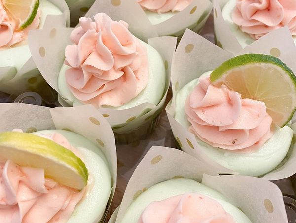 Cupcakes with pink frosting and lime slices.