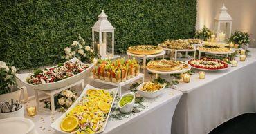 Elegant buffet table with a variety of appetizers and desserts.