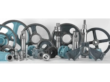 Various industrial gears and metal parts arranged together.