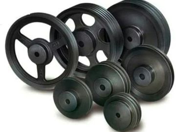 Various sizes of black industrial pulleys arranged together.