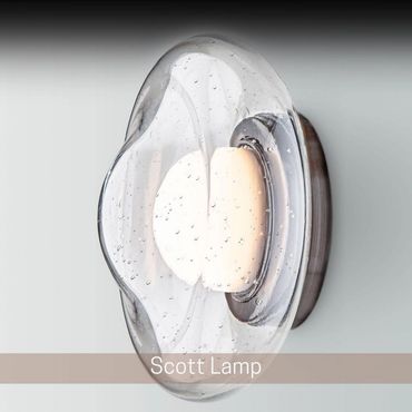 Illuminated wall sconce with a rounded, textured glass shade.