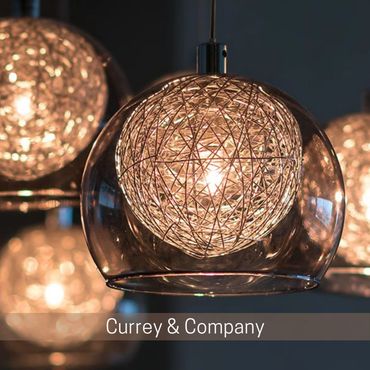 Glowing pendant light with a woven metal center inside a clear glass shade.