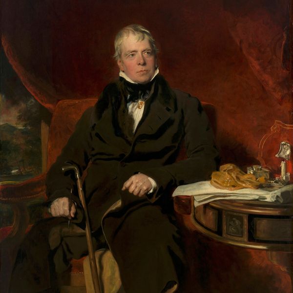 Portrait of a formal gentleman sitting with a cane.