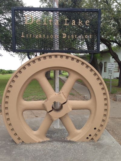 front of office view with large tan gear with district name