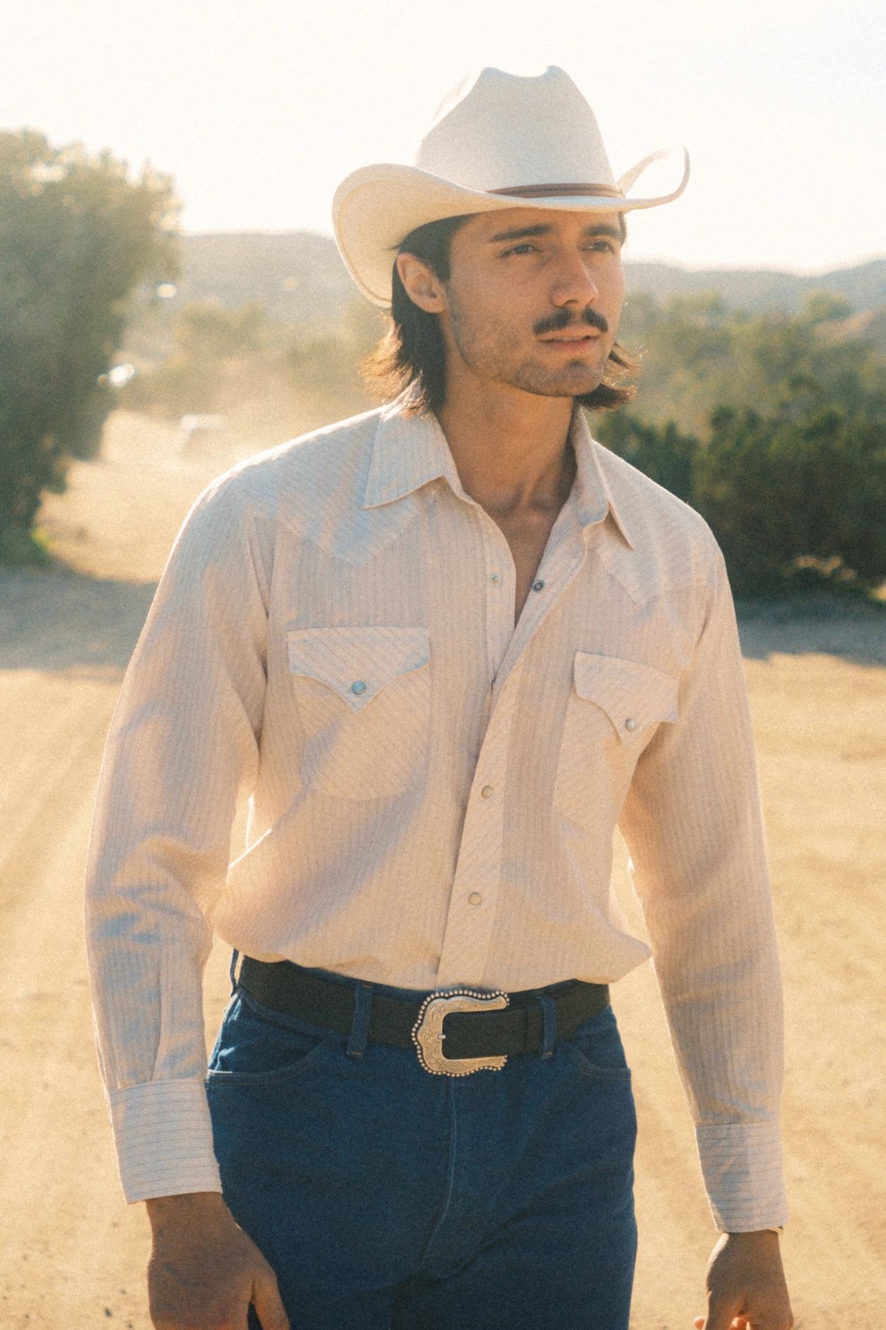 Matthew Frietze headshot as a cowboy.
