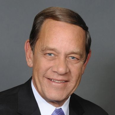 Smiling middle-aged man in suit and tie.