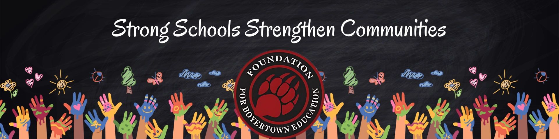 Colorful painted hands raised under the slogan about strong schools.