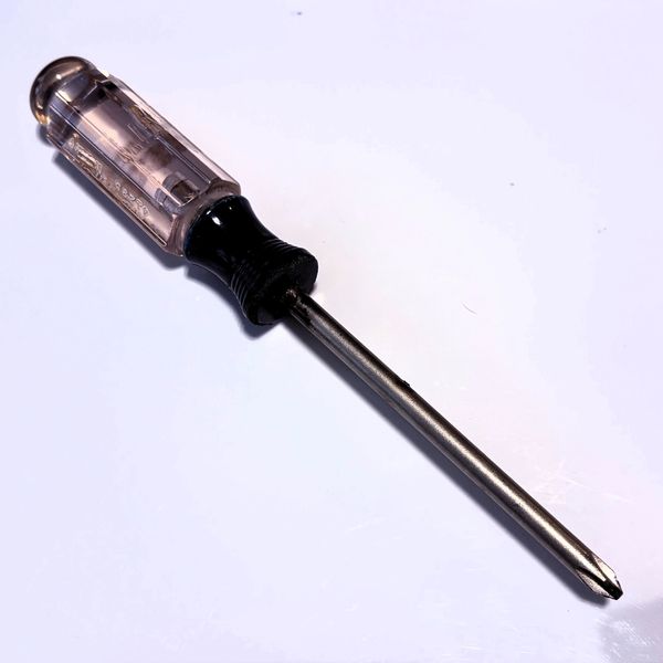 A Phillips head screwdriver with a transparent handle.