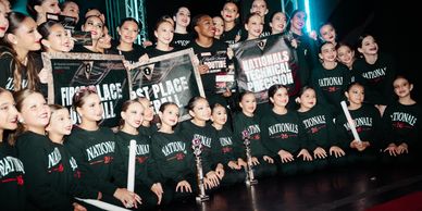 Dance team celebrating with awards.