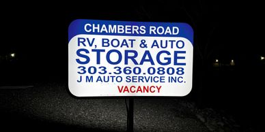 Illuminated sign for Chambers Road RV, Boat &amp; Auto Storage with vacancy notice.