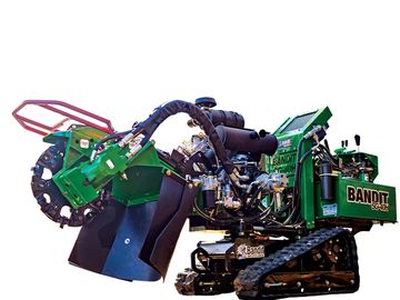 Green tracked wood chipper machine.