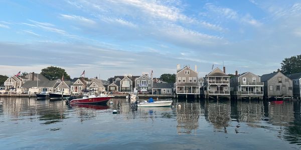 Waterfront houses and boats on a calm day.