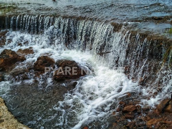 Small waterfall cascading over rocks.