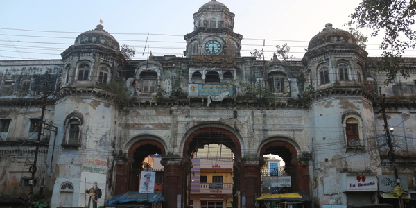 Old, historic building with a clock and archways.