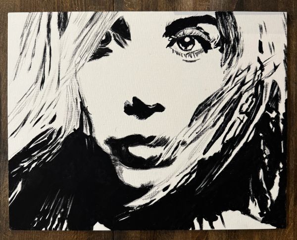 Black and white abstract portrait of a woman's face with expressive eyes.