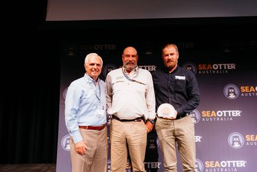 Three men posing at a Sea Otter Australia event.
