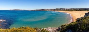 Panoramic landscape beach photography of Curl Curl, Sydney, Australia with turquoise clear ocean.