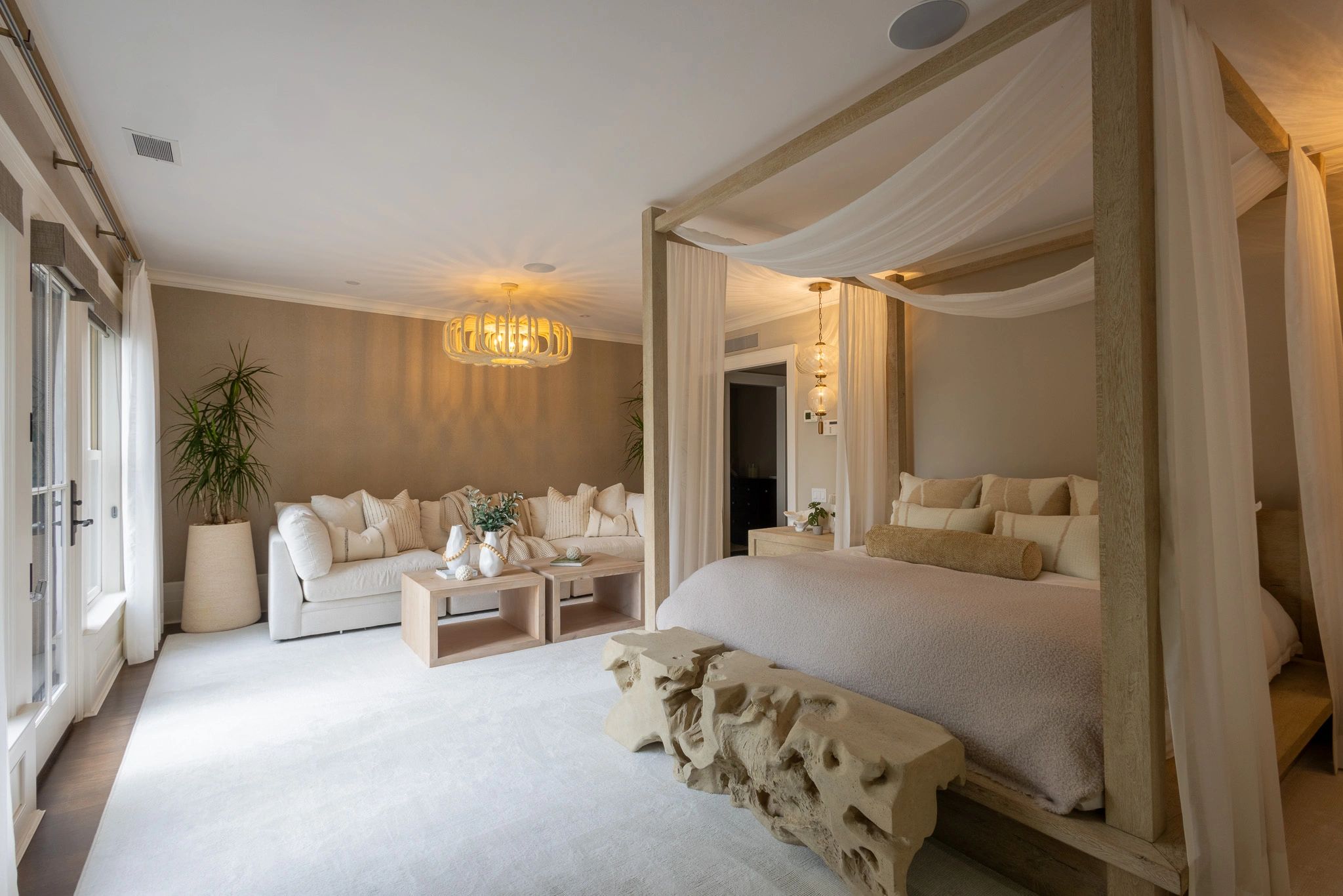 Cozy and elegant bedroom with a canopy bed and a comfortable sitting area.