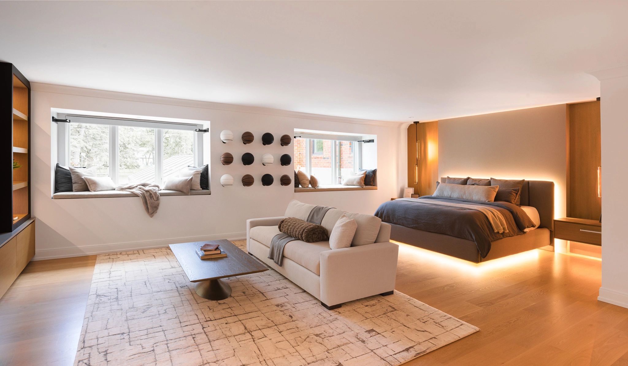Modern bedroom with cozy seating and creative wall decor.