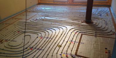 Underfloor heating pipes laid out before flooring installation.