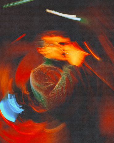 Blurred, abstract image with vibrant red and orange lights.