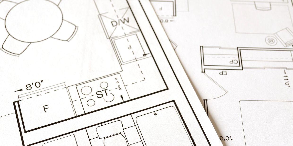 Blueprints and engineering diagrams on a desktop