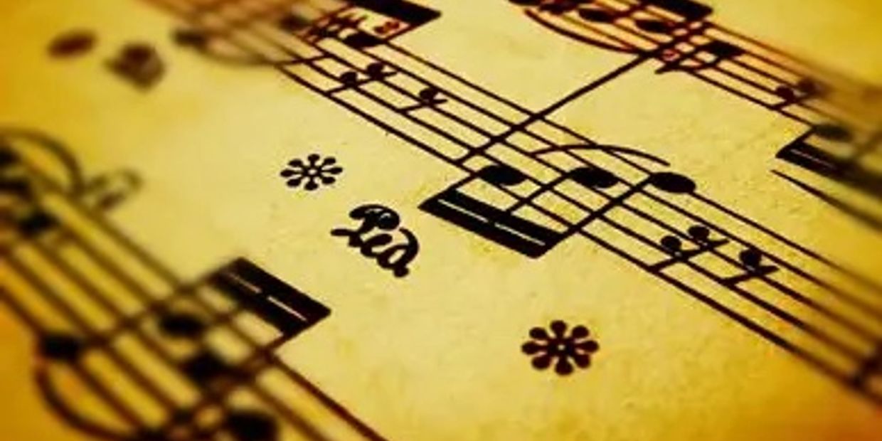 Close-up of vintage sheet music with musical notes and the word 'Ra'.