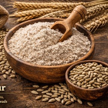 Wooden bowls with rye flour and rye grains.