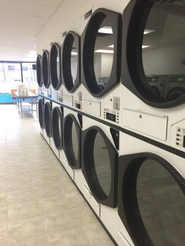 Row of stacked dryers in a laundromat.
