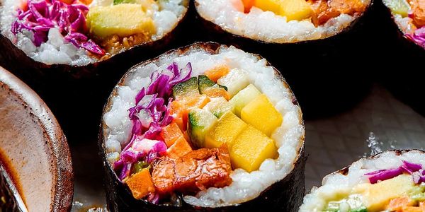 Colorful vegetable sushi rolls with vibrant ingredients wrapped in seaweed.