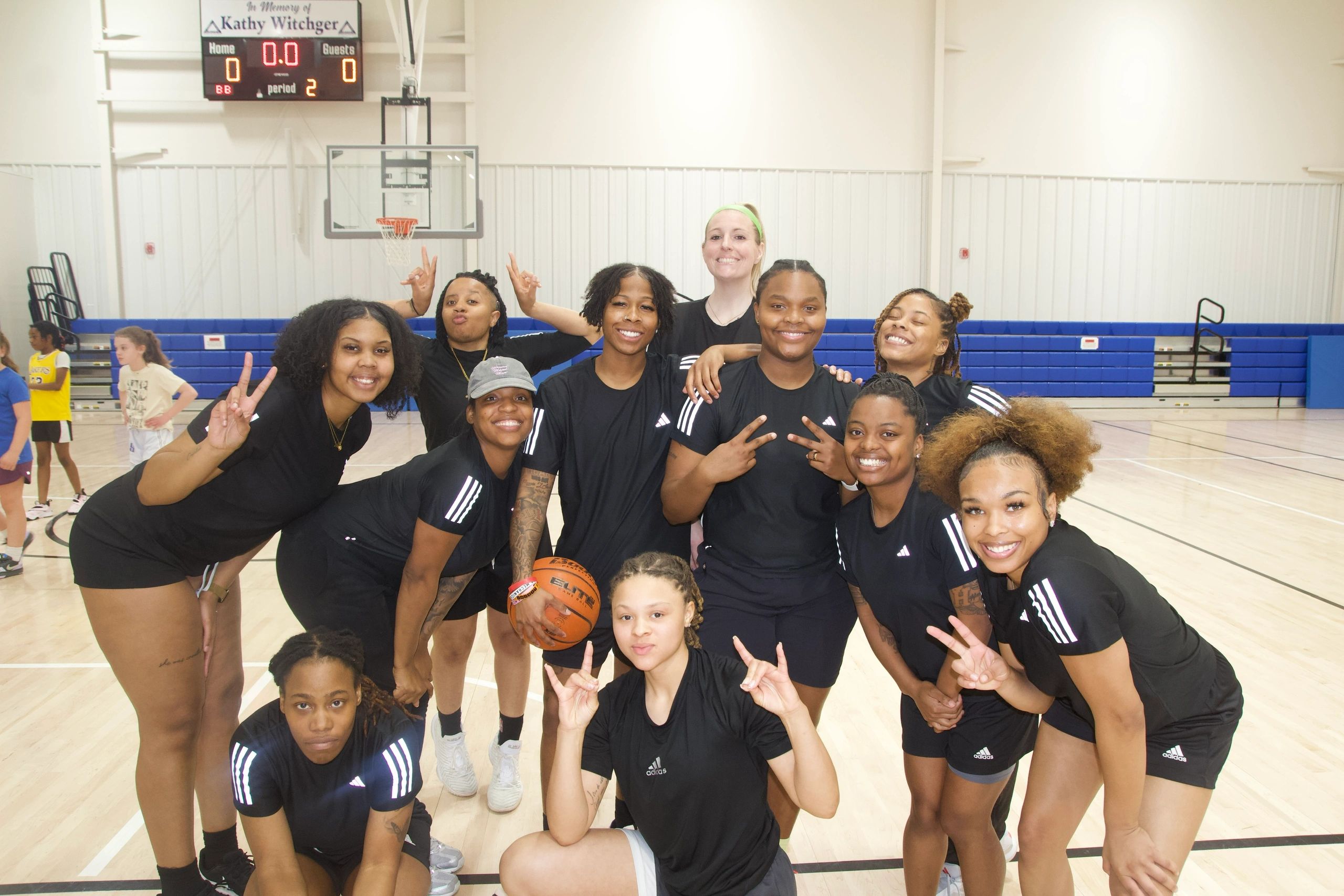 Wolves players and community participants together in the gym.