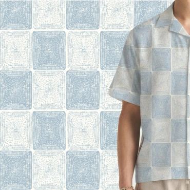 Shirt matches the patterned background with blue and white squares.