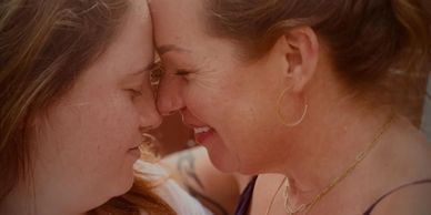 Two women sharing a tender, close moment.