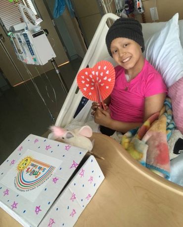 A patient in the hospital receiving a Smile Box while enduring difficult treatments. 