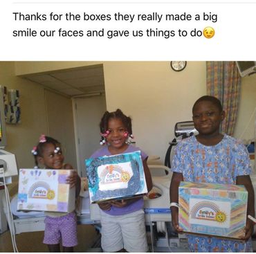 Patient and siblings receiving Smile boxes full of toys and activities.