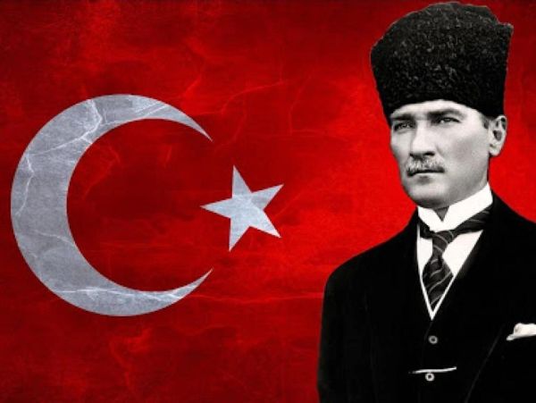 Portrait of Mustafa Kemal Atatürk with the Turkish flag background.