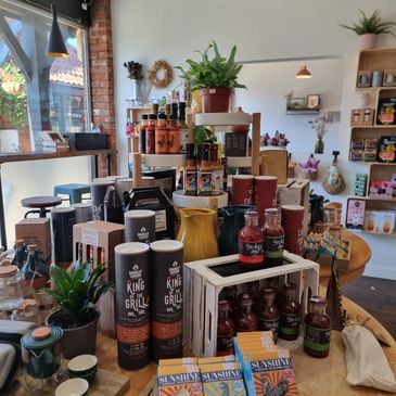 Display of gourmet sauces, chocolates, and kitchen items in a cozy shop.