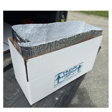 White seafood box with insulated lining on a truck bed.