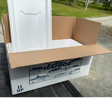 Open cardboard box with a white foam cooler inside, labeled for seafood.